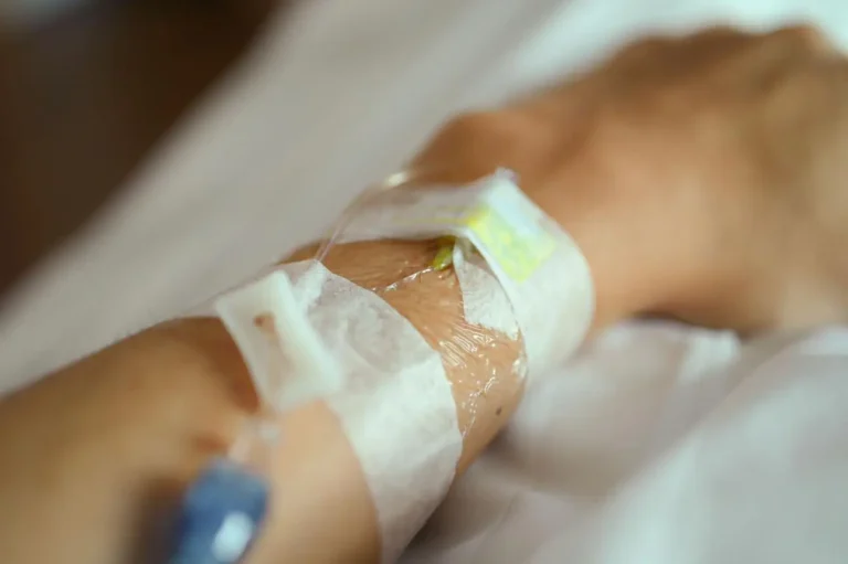 Nurse inserting IV cannula for intravenous fluid administration