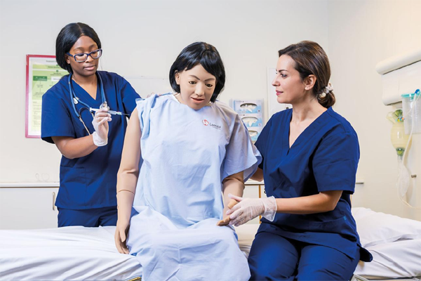 Nursing student practicing intramuscular medication administration using proper injection technique.