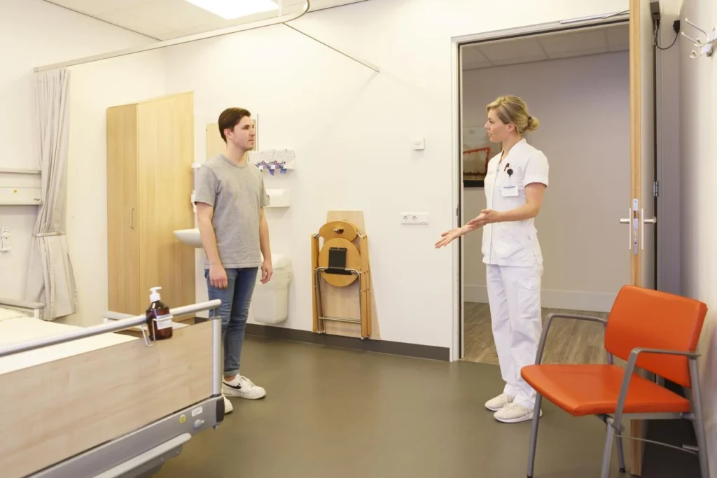 Nurse providing discharge instructions to hospital patient