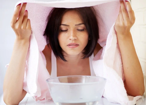 Bowl of hot water releasing steam used for steam inhalation therapy