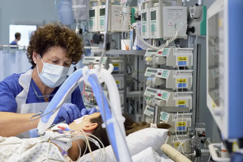 Healthcare professional managing airway suctioning for a mechanically ventilated patient