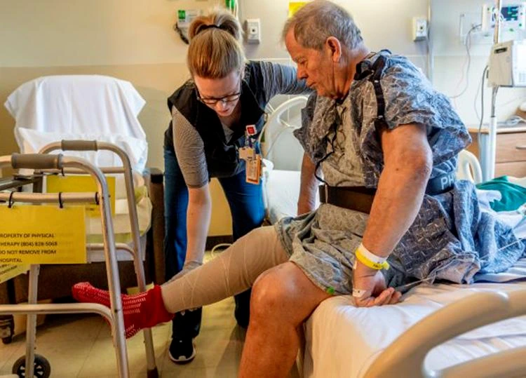 Postoperative patient performing gentle leg and ankle exercises in bed