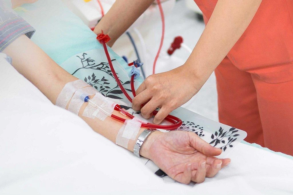 Nurse demonstrating proper dialysis access care for a patient receiving hemodialysis